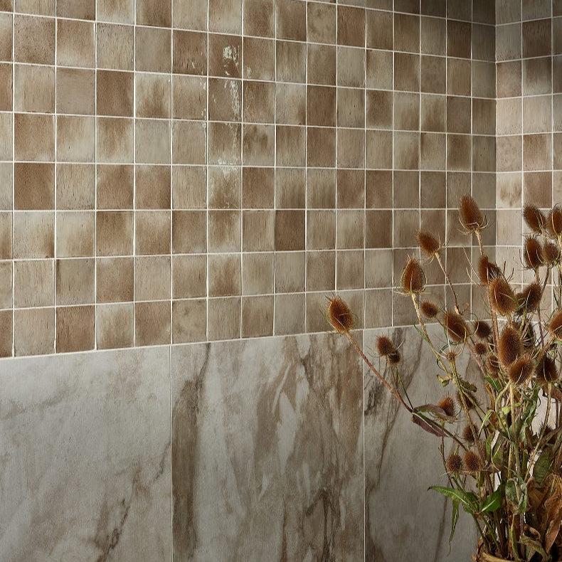 Image of Pottery oatmeal tiled wall with a vase of dried flowers