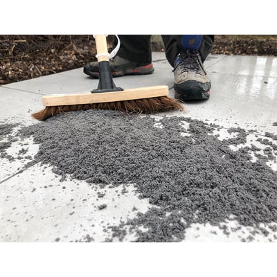 Image of sweeping grout into external tile grout joints 