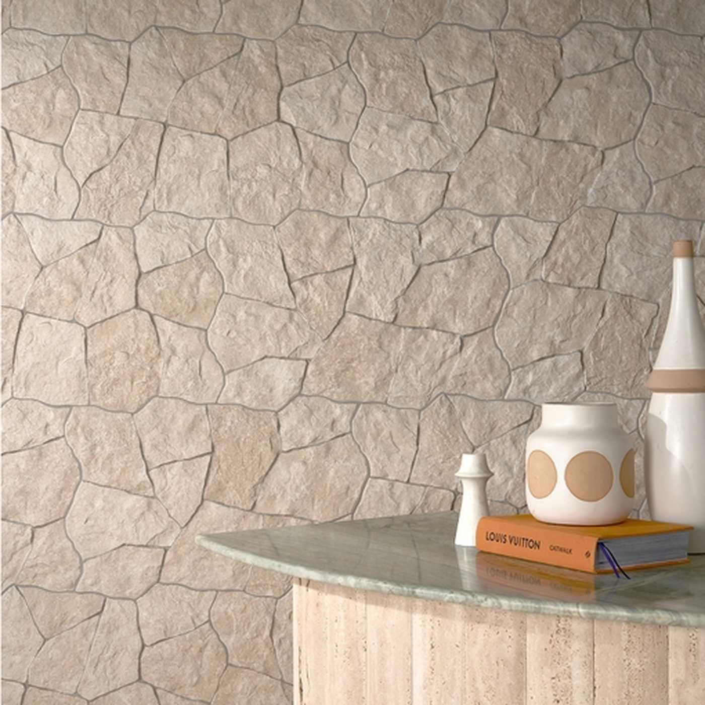 Image of Decorative stone wall with a table and decorative items.