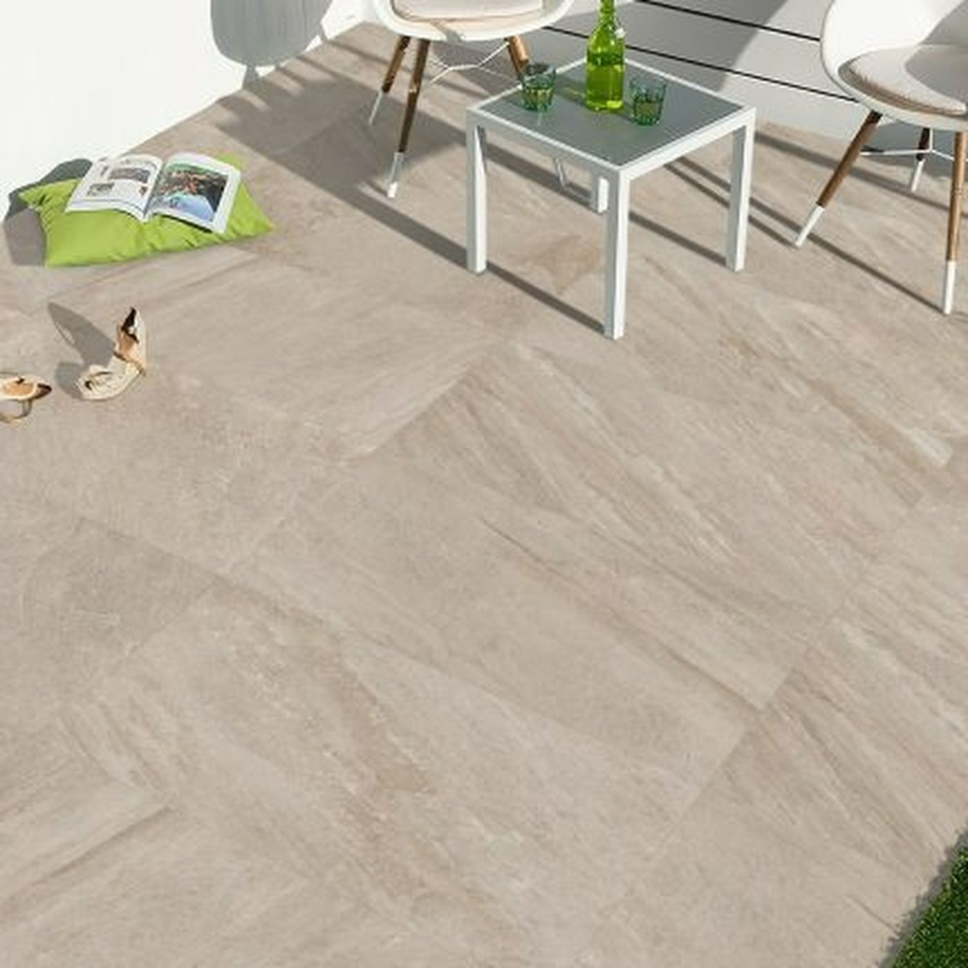 Image of Outdoor patio with herringbone patterned tiles, chairs, and a small table.