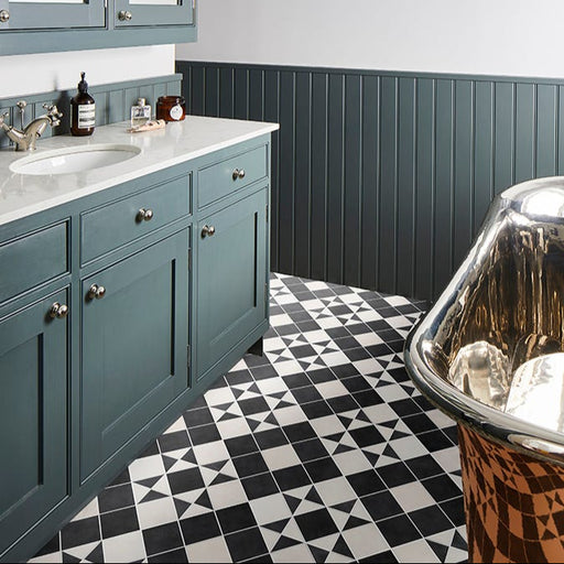 Bathroom with teal cabinets, marble countertop, and patterned floor.