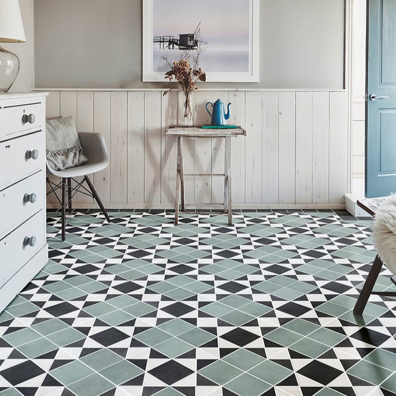 Image of Living room with geometric tile flooring, white walls, and a small table with decor items.