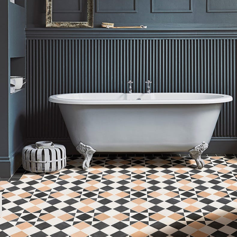 Image of Bathroom with a freestanding bathtub against a dark paneled wall with geometric tile flooring.