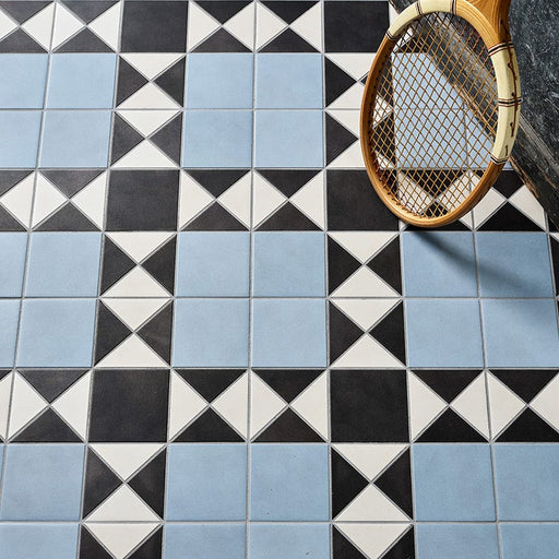 Geometric tile pattern with a vintage tennis racket on a textured surface