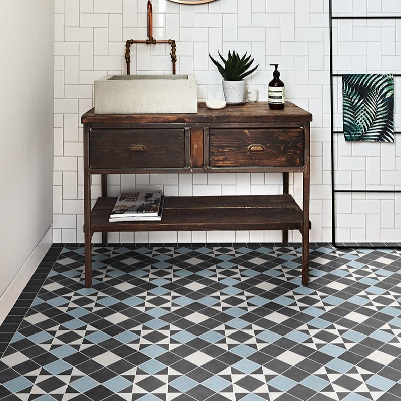 Image of Bathroom with wooden vanity, sink, and decorative elements on a tiled wall.