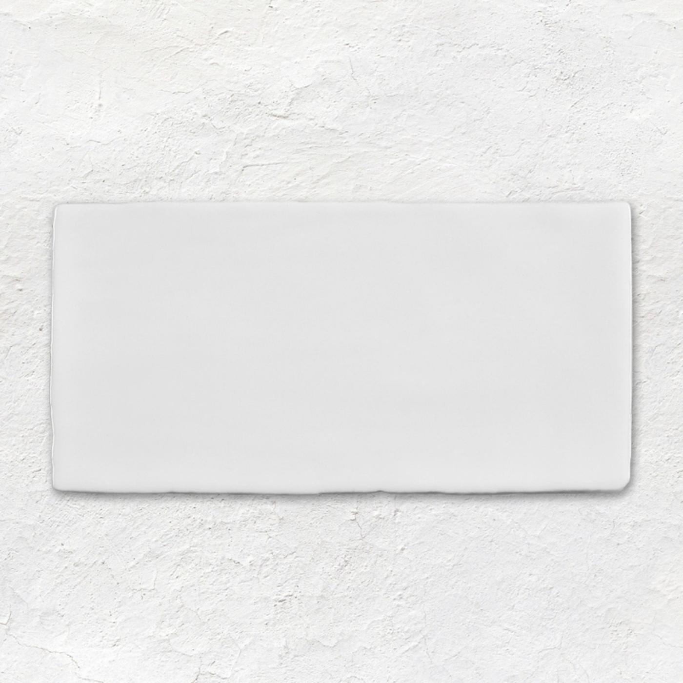 Image of A blank white rectangular tile or plaque with a slightly textured surface, centered on a white plaster-textured background.