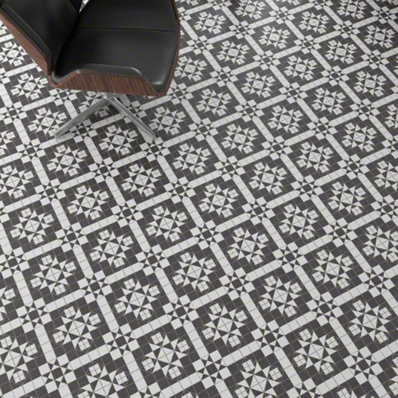 Harrow Grafito Pattern floor tiles 31.6x31.6cm with a black leather directors chair.
